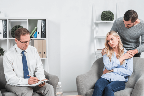 Clinical Counselling in Abbotsford session with therapist guiding a couple through relationship challenges.