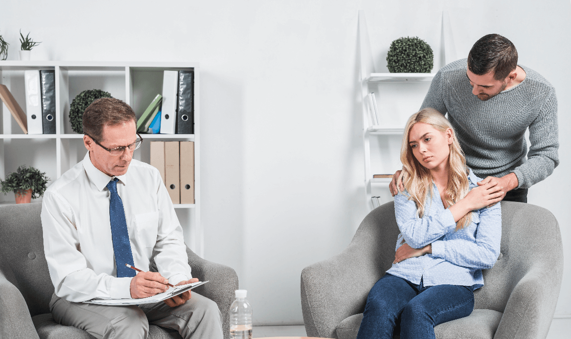 Clinical Counselling in Abbotsford session with therapist guiding a couple through relationship challenges.